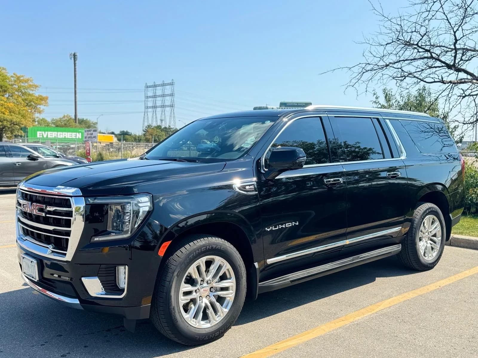 Black luxury SUV parked outdoors in daylight
