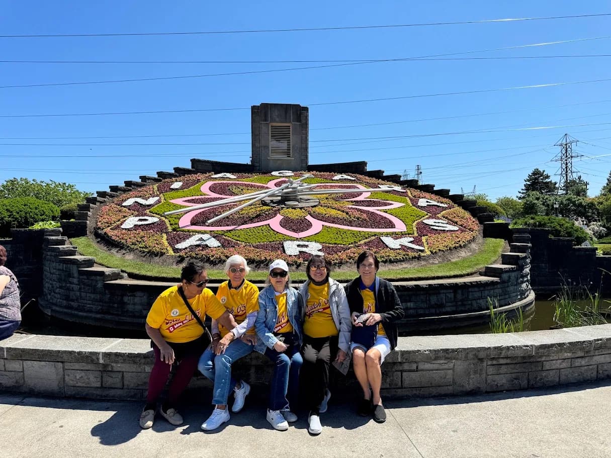 Private group posing together in front of the Niagara Floral Clock