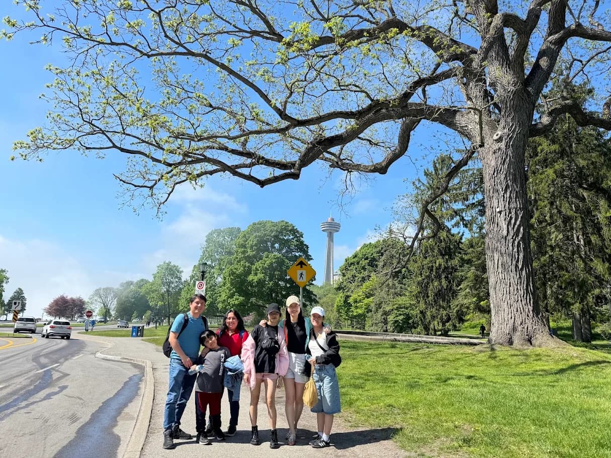 Private group posing with the Skylon Tower visible behind them