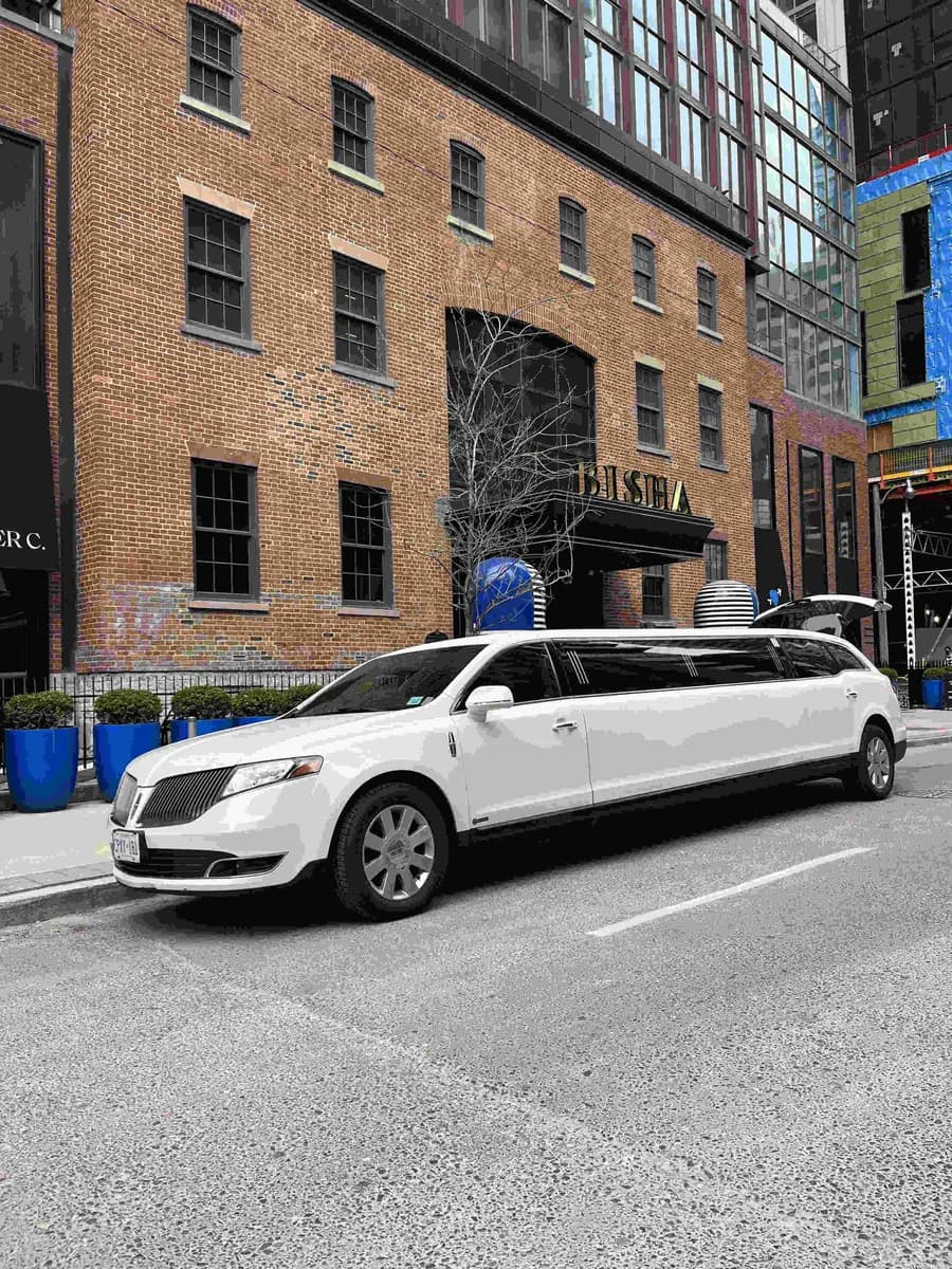 White stretch limousine parked on a city street