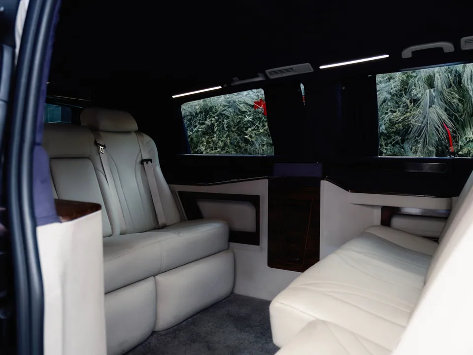 Stock image of spacious leather seating inside a passenger van